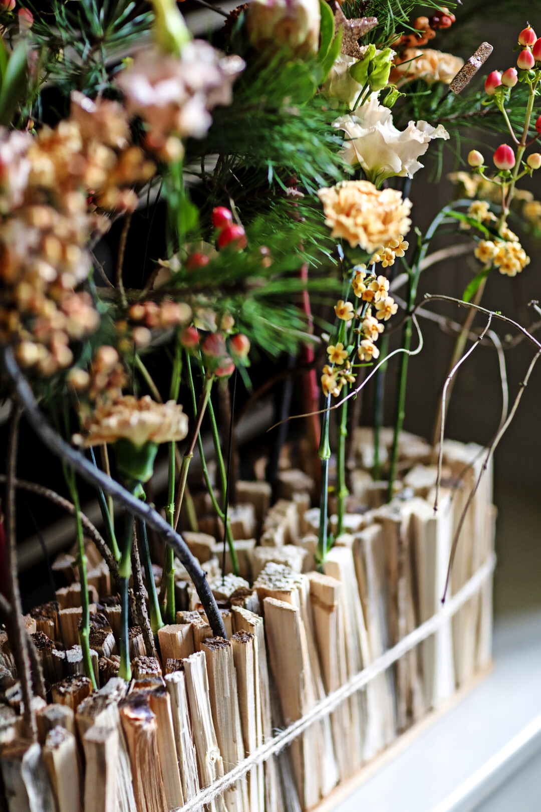 In eine Grundplatte aus Holz und in die Holzstcke wurden Lcher gebohrt. Durch diese Technik war es mglich, das Anfeuerholz zu befestigen. Die Freirume wurden mit Reagenzglsern gefllt.