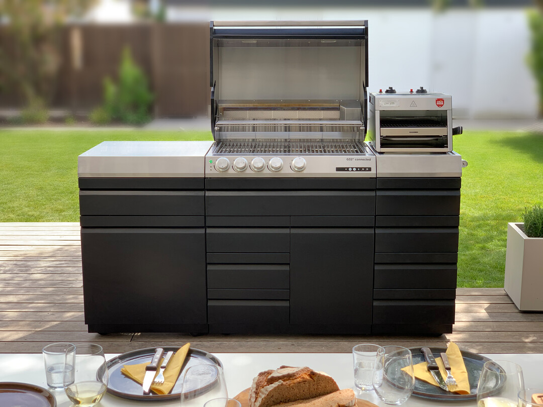 Im G32 Gasgrills von Otto Wilde sind vier gegossene Edelstrahlbrenner verbaut. Der Grillrost misst 77 x 45 cm und bietet damit genug Platz, um eine groe Grillgesellschaft zu bewirten. Zur Nutzung der vollen Breite wurde ein extra langer Rotisserie-Brenner entwickelt. Damit lassen sich auch ganze Puten oder Spanferkel braten. Das FatManagementSystem macht die Reinigung einfach. Es besteht aus zwei Schalen, die in eine Splmaschine passen und in einer Teleskopschublade untergebracht sind. Per Smartphone lsst sich  ablesen, was auf dem G32 geschieht, und manuell eingreifen, sobald es notwendig ist.